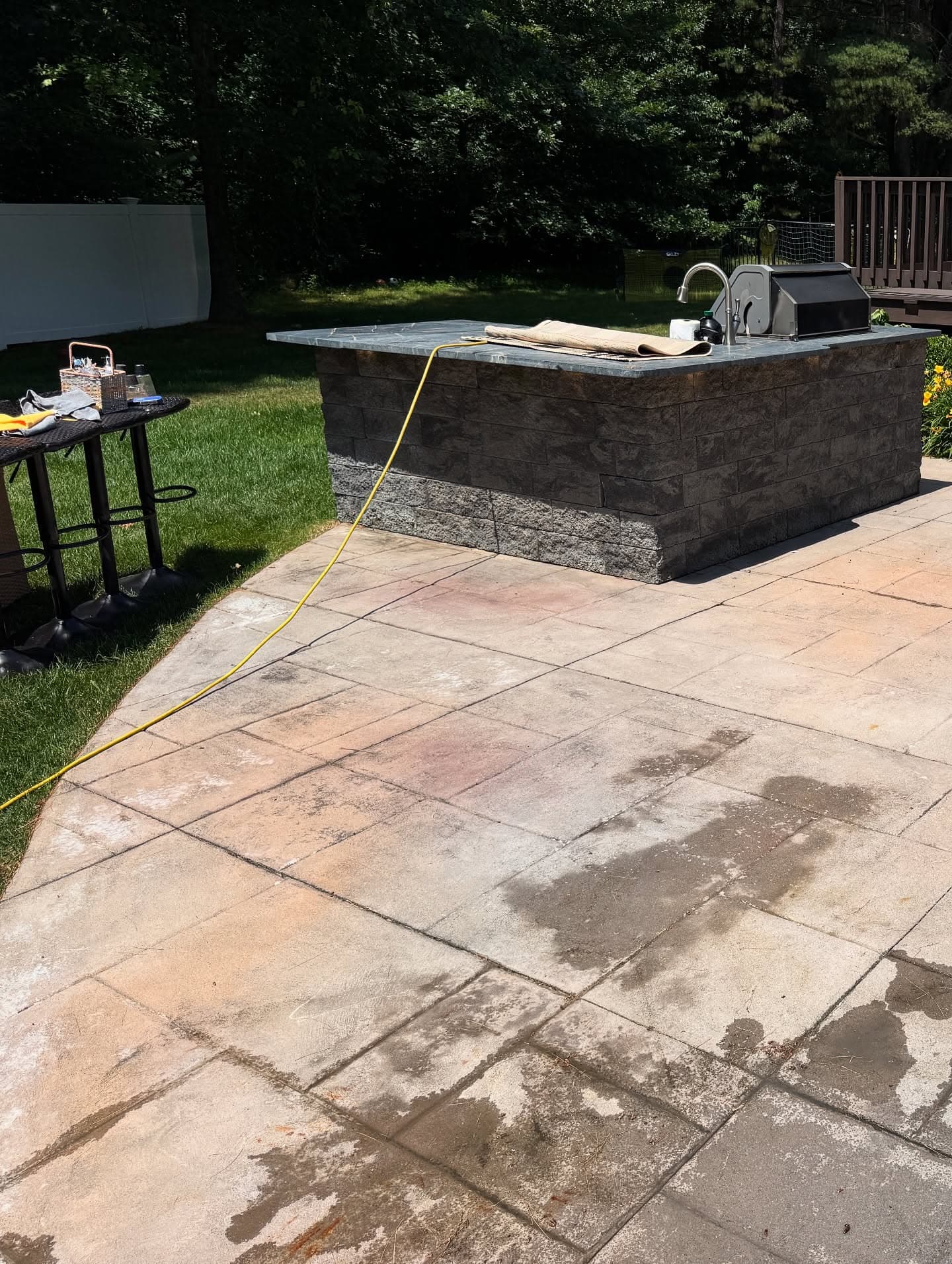 Driveway covered in oil stains and dirt before cleaning